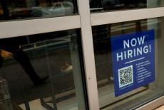 FILE PHOTO: An employee hiring sign with a QR code is seen in a window of a business in Arlington