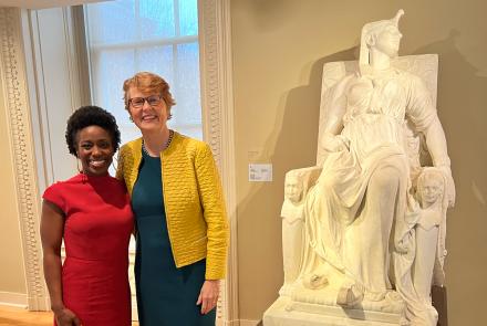 Felicia Curry and Stephanie Stebich in front of a statue