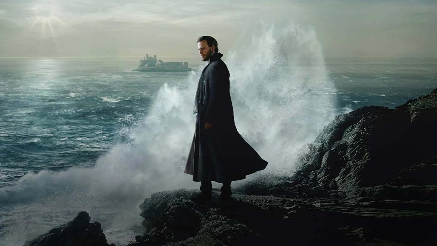 Monte Cristo standing on jagged rocks with waves crashing